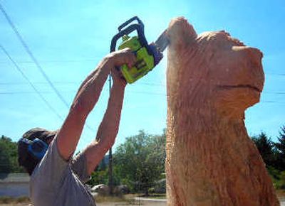 
Arthur Grant Jones carves red fir logs into bears for a customer.
 (Jennifer LaRue / The Spokesman-Review)