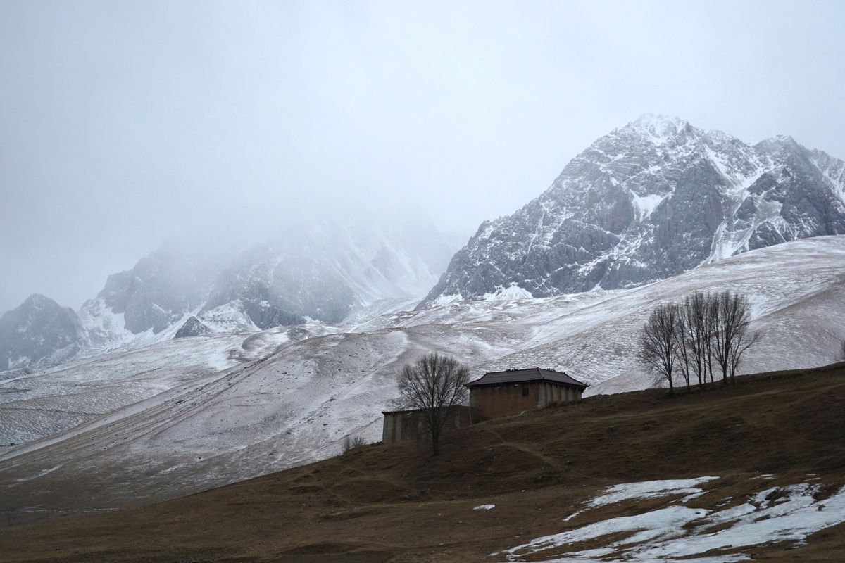 A house stands in the shadow of snow-capped mountains in predominantly Tibetan Garze county in southwestern China’s Sichuan province earlier this month. (Dake Kang)