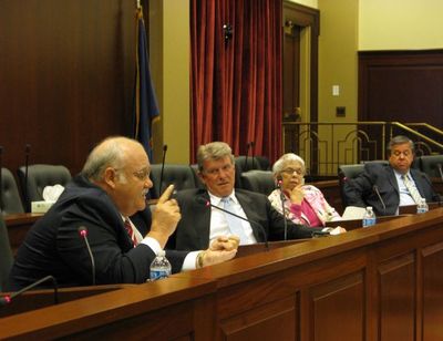 Idaho Secretary of State Ben Ysursa, left, discusses questions about selling or exchanging state-owned lake cabin sites, as Gov. Butch Otter, state Controller Donna Jones and state schools Supt. Tom Luna listen on Tuesday. Attorney General Lawrence Wasden participated in the Land Board meeting by phone; the state is moving forward with the sale/exchange plan, but board members cautioned it could take longer than some expect. (Betsy Russell)