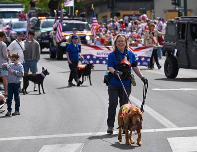 Search dog Trio leads handler Martha Stone down Sherman Avenue in  (Jesse Tinsley/THE SPOKESMAN-REVIEW)