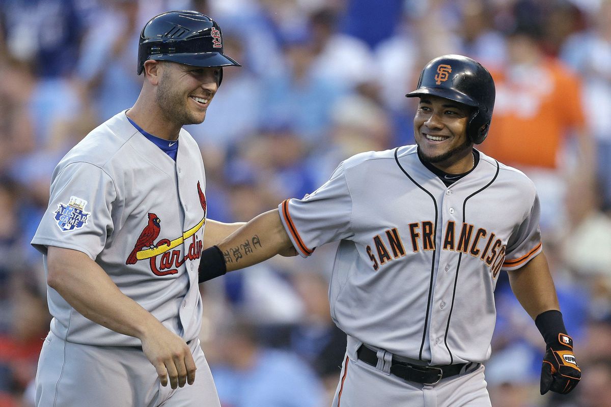 Melky Cabrera, right, of the San Francisco Giants celebrates his two-run home run with Matt Holliday of the St. Louis Cardinals. (Associated Press)