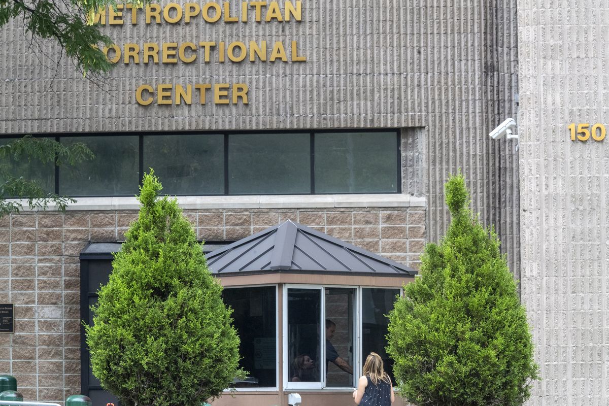 In this Aug. 13, 2019 photo, an employee checks a visitor outside the Metropolitan Correctional Center in New York. Federal officials said Thursday, Aug. 26, 2021, they are shutting down the embattled jail in New York City after a slew of problems that came to light following Jeffrey Epstein’s suicide there two years ago.  (Mary Altaffer)