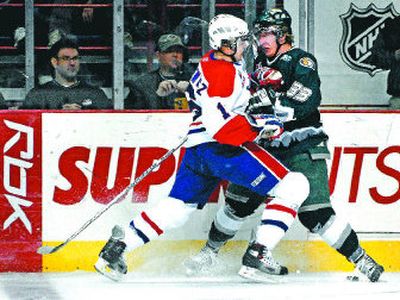 
Spokane's J. P. Szaszkiewicz, left, and Everett's Lukas Vartovnik battle for the puck during Tuesday's Western Hockey League game. 
 (Holly Pickett / The Spokesman-Review)