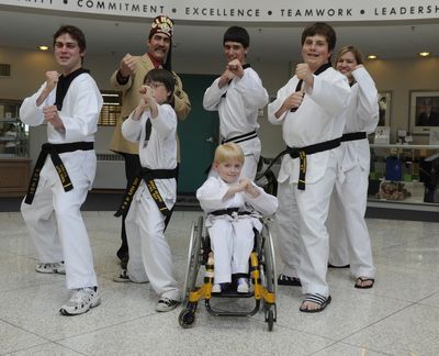 Jung Kim’s martial arts studio will  hold a board break-a-thon fundraiser to benefit  Shriners Hospital for Children.  Former and current Shriners patients, left to right, Tyler Schmidt,  Grant Gilmore,  Spencer Young, Jerrod Galles (in back), Ryan Thompson and Gayle Gracio, shown with El Katif Shrine Potentate Von Chimienti, are taking sponsor pledges for Saturday’s event at Gonzaga Prep. (Colin Mulvany)