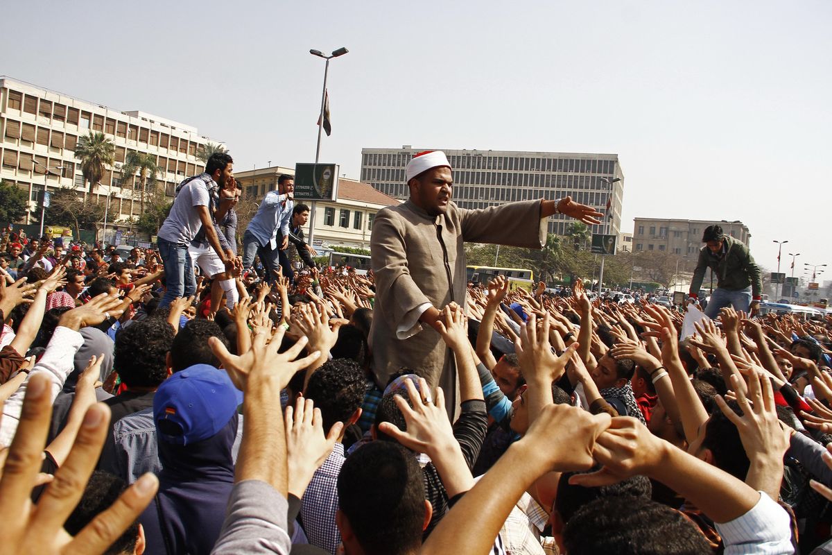 Supporters of ousted President Mohammed Morsi chant slogans during a demonstration outside Cairo University in Giza, Egypt, on Wednesday. Hundreds of students at a number of universities protested Wednesday against the death sentences issued against more than 500 suspected supporters of Morsi in a cursory trial. (Associated Press)