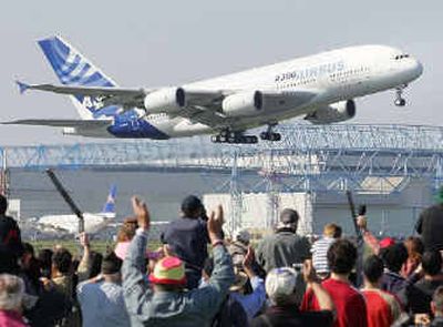 
Spectators cheer as the Airbus A380, the world's largest passenger plane, takes off successfully on its maiden flight on Wednesday. The 555-seat superjumbo is expected to enter service in mid-2006.
 (Associated Press / The Spokesman-Review)
