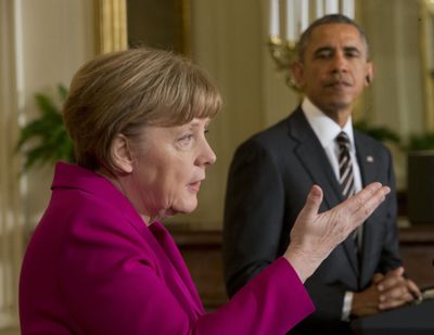 President Barack Obama listens as German Chancellor Angela Merkel speaks during their news conference in the East Room of the White House in Washington on Monday. (Associated Press)