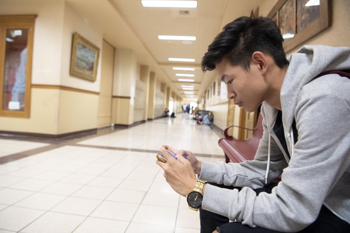 Bekalpa Rai plays a video game on his phone at  lunch Tuesday, Sept. 25, 2018 at Lewis and Clark High School.  Phones must be secured during class time but can be used during lunch. Jesse Tinsley/THE SPOKESMAN-REVIEW (Jesse Tinsley / The Spokesman-Review)