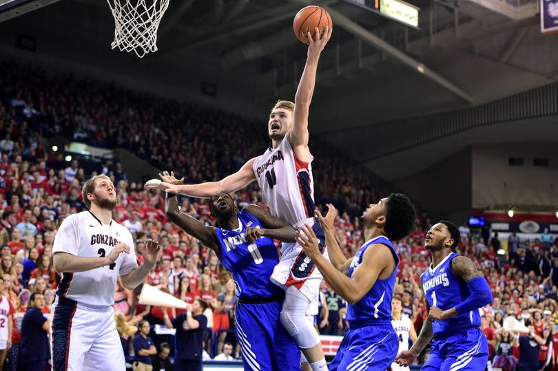 Gonzaga forward Domantas Sabonis (11) shoots over Memphis during the first half of a college basketball game on Saturday, Jan 31, 2015, at McCarthey Athletic Center in Spokane, Wash.  Przemek Karnowski looks on. Sabonis, Karnowski and Kyle Wiltjer are three reasons why the Zags are ranked No. 11 in the nation in a coaches' preseason poll. (File photo/Spokesman-Review)