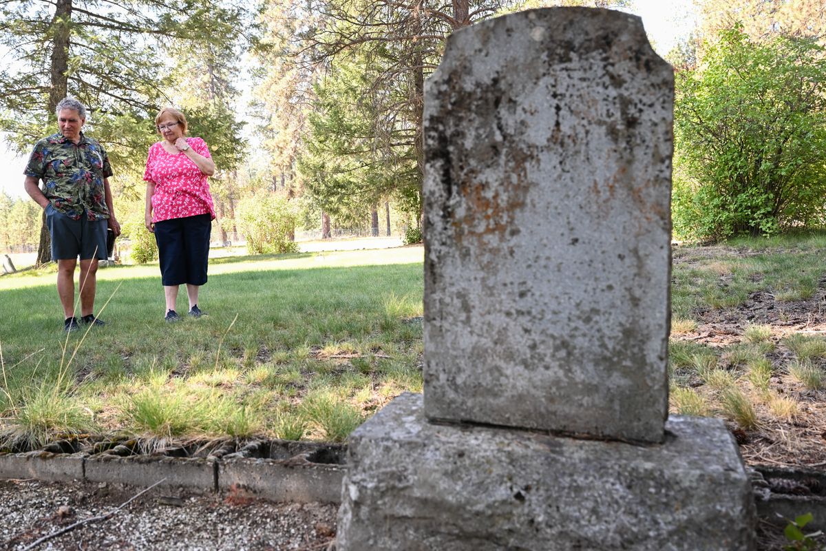 James Pittman, left, and Kathy Munk, secretary for the Milan Cemetery District, pause while being interviewed about the difficulties of maintaining a small rural cemetery Wednesday at Milan Cemetery in Chattaroy. (Tyler Tjomsland/The Spokesman-Review)