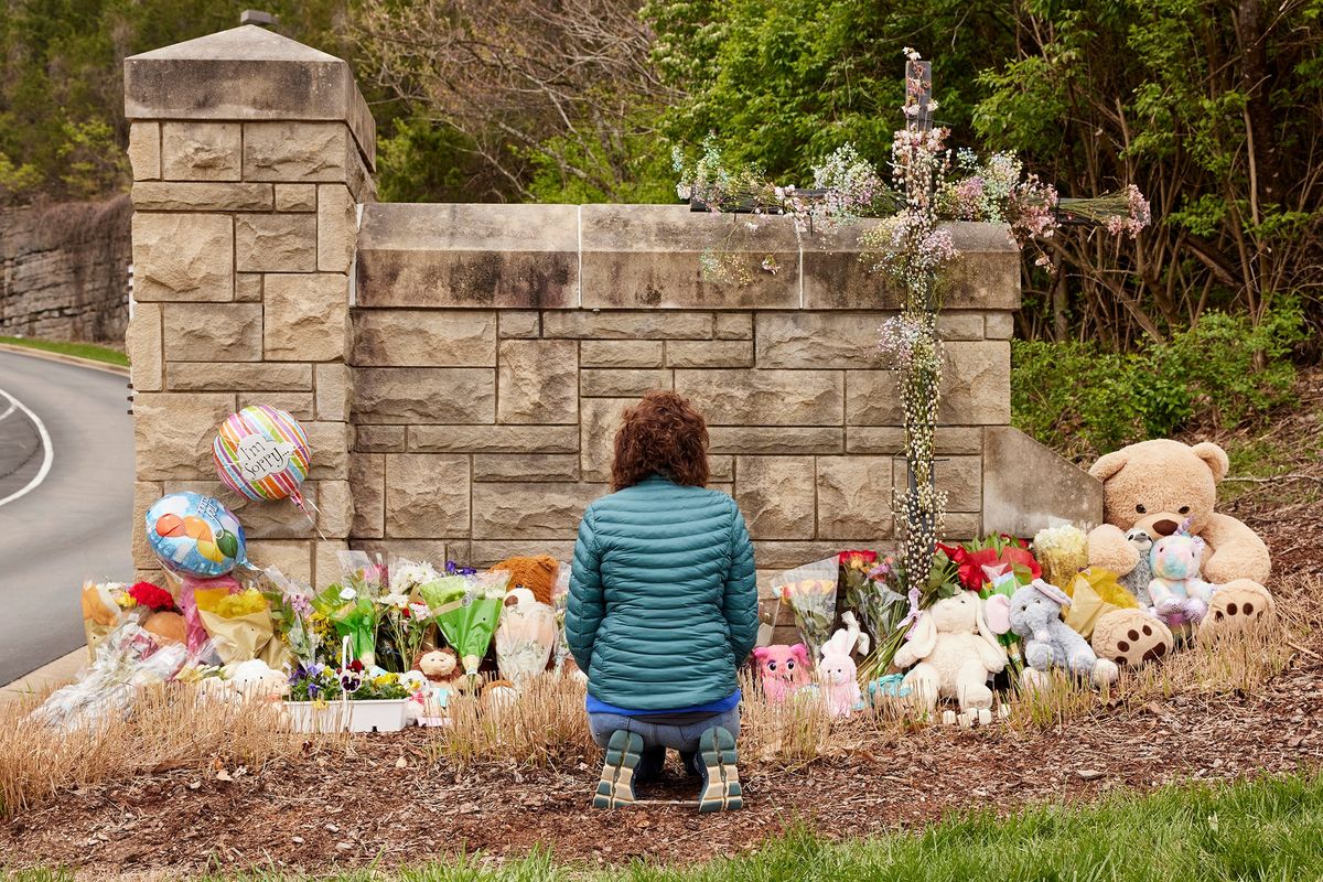 A woman prays at a makeshift memorial for victims of Monday’s shooting outside the Covenant School building at Covenant Presbyterian Church in Nashville.  (Johnnie Izquierdo/For The Washington Post)