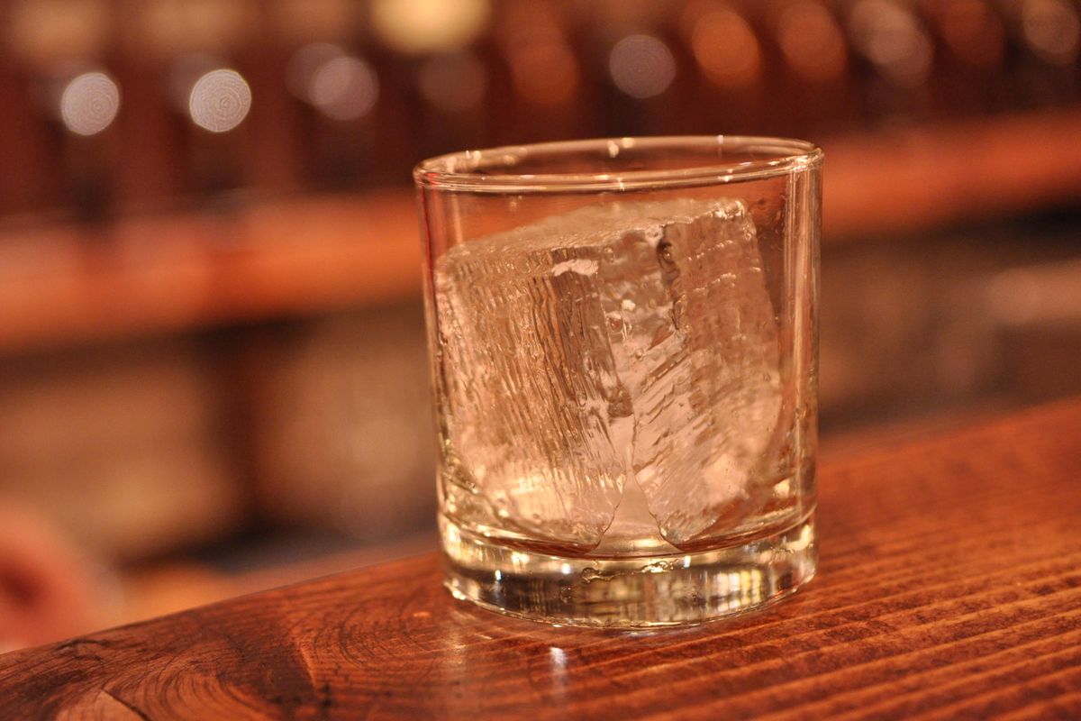 This Hogwash Whiskey Den glass holds a cube of ice a hand-carved by bartender Simon Moorby. (Adriana Janovich / The Spokesman-Review)