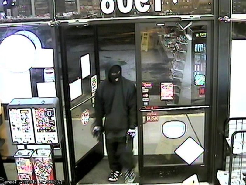 Spokane police today released surveillance photos of a robbery last week at a Browne's Addition convenience store in hopes someone will recognize the gunman.
The robbery was reported about 11:49 p.m. Feb. 29 at the Sunset Grocery, 1908 W. Sunset Blvd.
The gunman is described as 20 to 22 years old, 5-foot-5 to 5-foot-7 and 150 to 160 pounds. He wore a black knit ski mask, dark hooded sweatshirt, black coat, dark loose pants and black and white athletic shoes. The gun is described as a black semi-automatic pistol.
 (survellience)