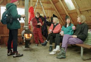 
Cross-country skiers  take a break for cookies and hot chocolate in the warming hut at Fourth of July Pass. 
 (The Spokesman-Review)