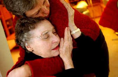 
Carol Fernlund, center, hugs her daughter, Cynthia Taggart, during a recent visit at her home in Coeur d'Alene. Carol had a mastectomy last month, and her doctor offered the option of going home after surgery. She declined and stayed overnight at the hospital. 
 (Kathy Plonka / The Spokesman-Review)
