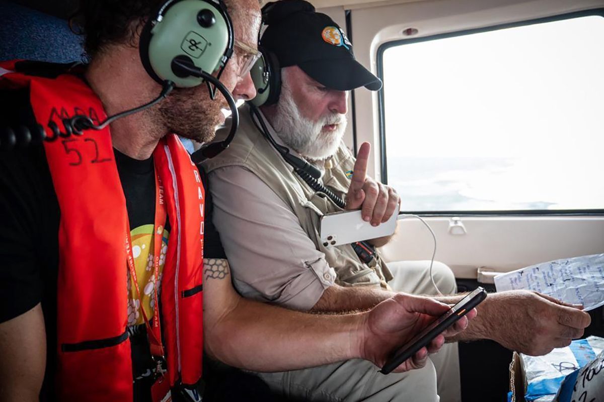 Sam Bloch of World Central Kitchen and chef José Andrés discuss their written plan on a helicopter flying over the Abaco Islands in the Bahamas after Hurricane Dorian in a scene from the documentary “We Feed People.”  (National Geographic/Sebastian Lindstrom)