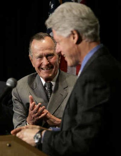 
Former President George H.W. Bush, left, applauds former President Bill Clinton during a speech at a private sector summit on tsunami reconstruction held by the U.S. Chamber of Commerce on Thursday, in Washington. 
 (Associated Press / The Spokesman-Review)