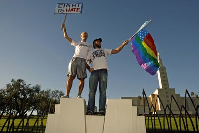 Patrick Ghougassian, left, and Win Croft protest in front of the Mormon Church in Los Angeles on Thursday. Gay rights activists have filed a legal challenge to California’s new ban on gay marriage.  (Associated Press / The Spokesman-Review)