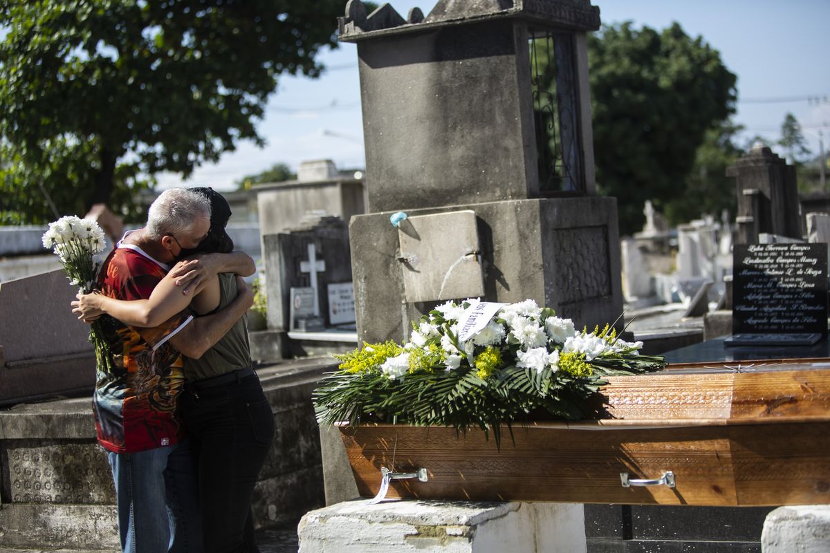 Relatives grieve Wednesday at the burial service for Monica Cristina, 49, who died from complications related to COVID-19, at the Inahuma cemetery in Rio de Janeiro.  (Bruna Prado)