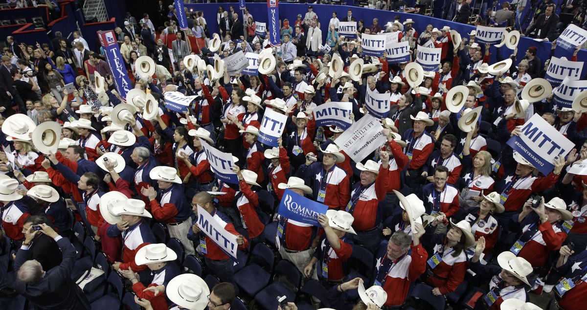 Delegates cheer after the majority of their votes were cast for Mitt Romney during the Republican National Convention on Tuesday. (Associated Press)