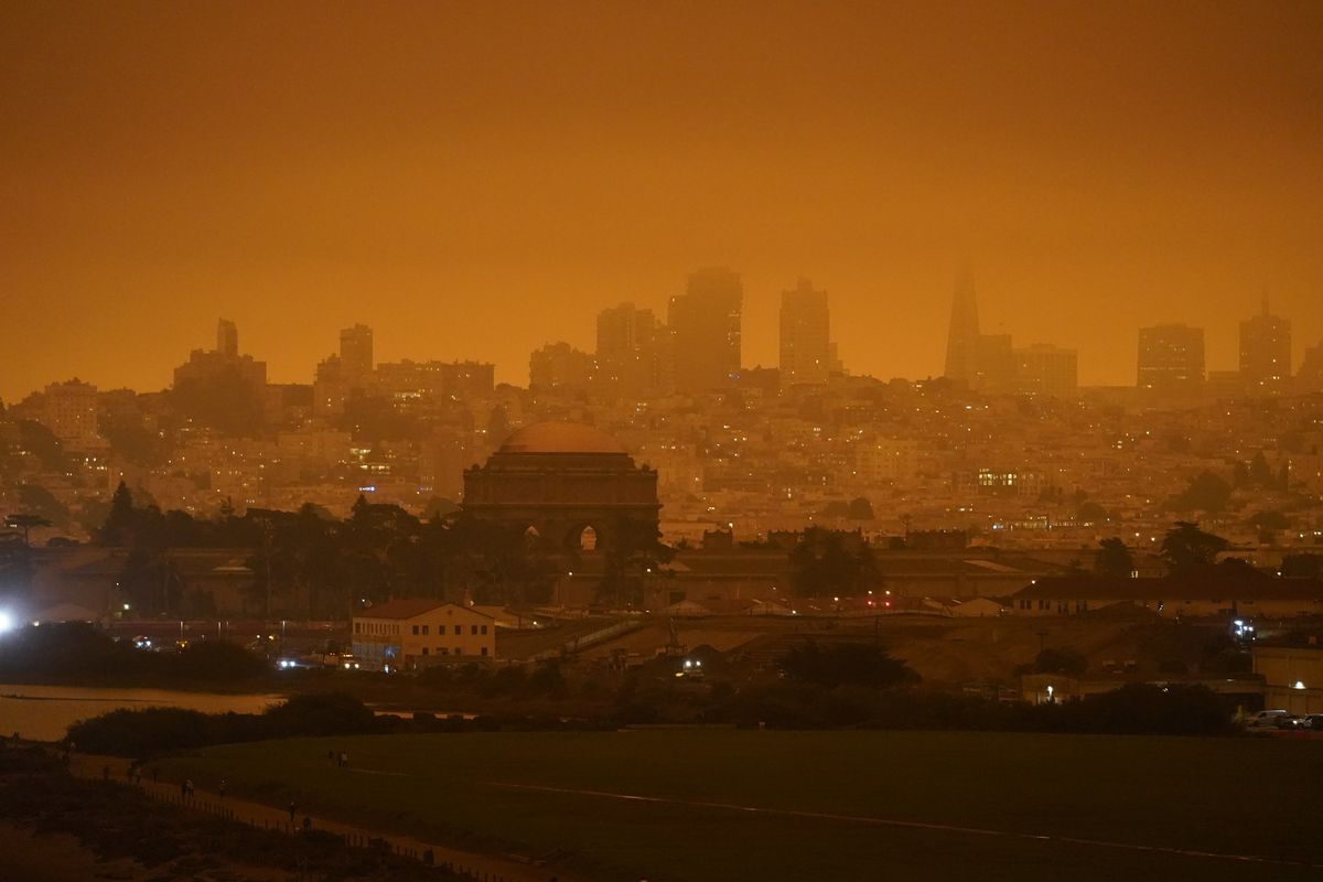 FILE - In this Sept. 9, 2020, file photo, taken at 11:18 a.m., is a dark orange sky above Crissy Field and the city caused by heavy smoke from wildfires in San Francisco. Wildfires that scorched huge swaths of the West Coast churned out massive plumes of choking smoke that blanketed millions of people with hazardous pollution that spiked emergency room visits and that experts say could continue generating health problems for years. An Associated Press analysis of air quality data shows 5.2 million people in five states were hit with hazardous levels of pollution for at least a day. (Eric Risberg)