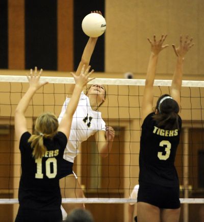 Alexis Olgard, center, stretches to her full height of 6 feet, 5 inches, and brings it almost straight down on LC defenders.   (Jesse Tinsley / The Spokesman-Review)