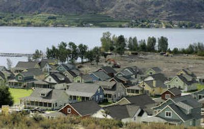 
Newly built cottages are shown on the shore of Lake Osoyoos,which straddles the U.S.-Canada border, in Oroville, Wash. Many Canadians are buying the Washington land.Associated Press
 (Associated Press / The Spokesman-Review)
