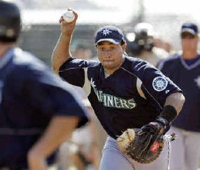 
Seattle's Miguel Olivo, announced as the team's No. 1 catcher, works during a spring training drill two weeks ago. 
 (Associated Press / The Spokesman-Review)