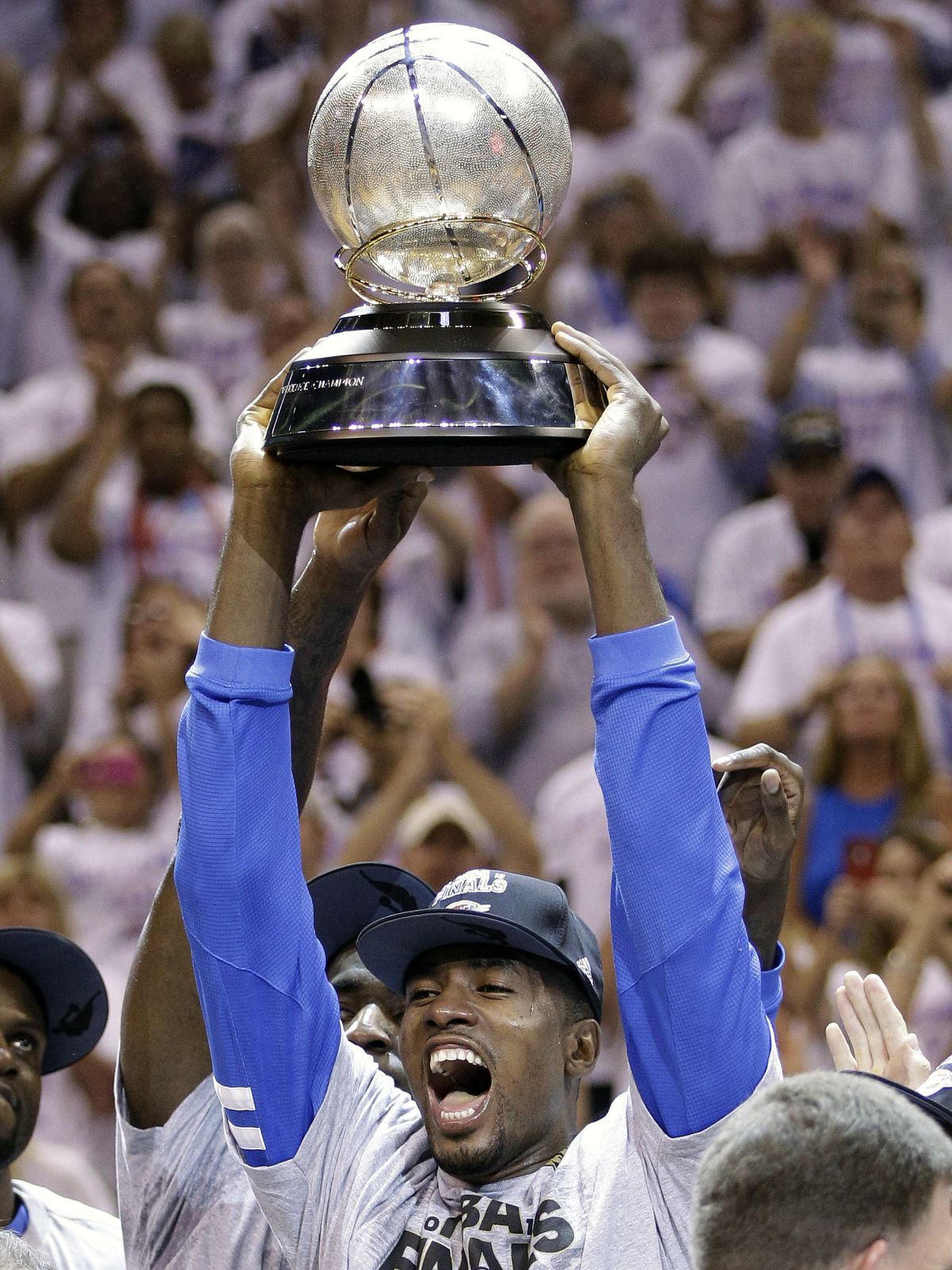 Oklahoma City Thunder power forward Serge Ibaka celebrates with the Western Conference trophy. (Associated Press)