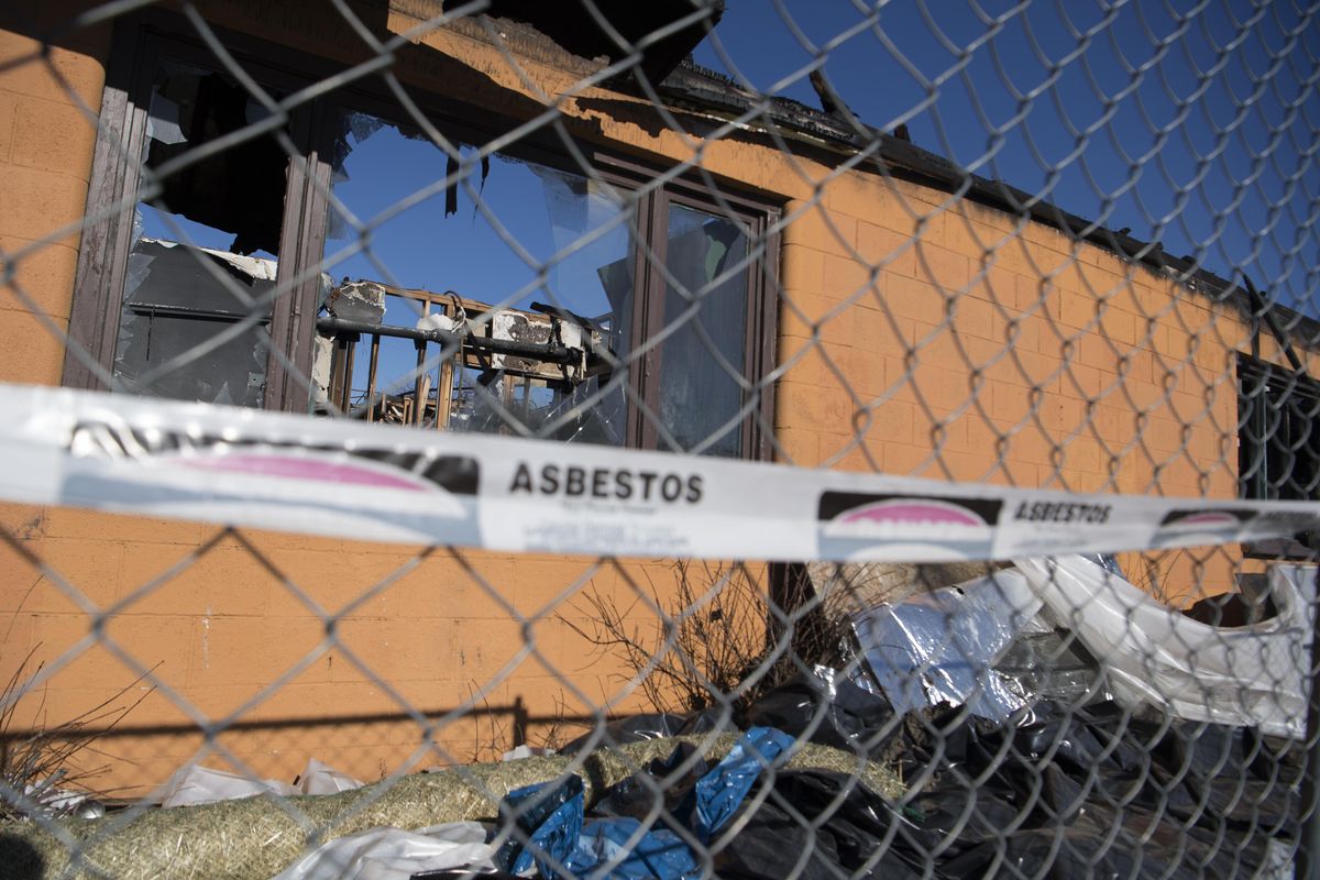 A burned out building on Wellesley between Market and Haven in Hillyard still stands with warning tape referencing asbestos danger, shown Tuesday, Feb. 13, 2018. (Jesse Tinsley / The Spokesman-Review)