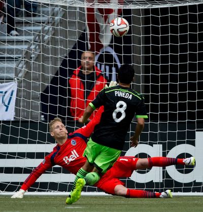 Gonzalo Pineda chips in a late penalty to bring Seattle level with the Whitecaps at 2-2. (Associated Press)