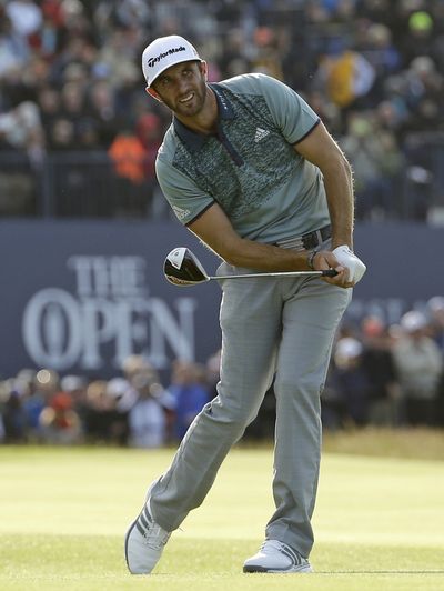 British Open second-round leader Dustin Johnson of the United States surveys his shot as he drives the green on the 18th hole, leading to a 3-under-par 69 and a one-stroke advantage over Danny Willett. (Associated Press)