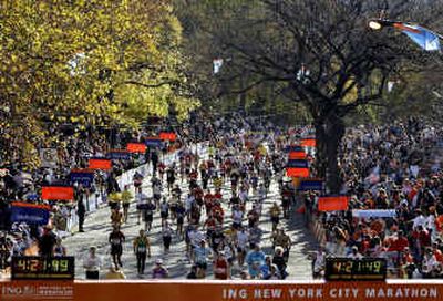 
Runners in the New York City marathon approach the finish line in Central Park Sunday.
 (Associated Press / The Spokesman-Review)