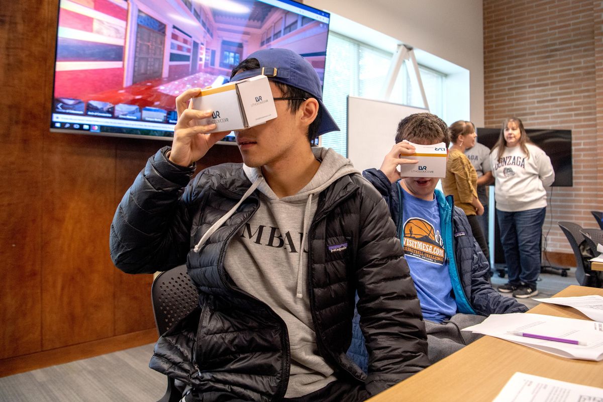Gonzaga University students Jonas Hyllseth and Reid Martinez use their cellphones and virtual reality to explore the digital re-creation of a house in ancient Pompeii during Andrew Goldman’s history class on Oct. 4. (Jesse Tinsley / The Spokesman-Review)