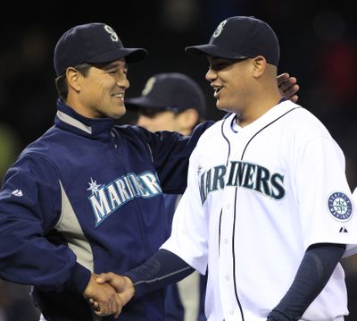 Seattle Mariners starting pitcher Felix Hernandez, right, is congratulated by manager Don Wakamatsu after Hernandez pitched a complete game against the Baltimore Orioles on Wednesday.  (Elaine Thompson / Associated Press)