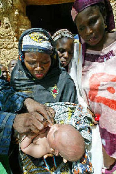 
A child is immunized against polio Saturday at a village near Takai, in the northern Nigerian state of Kano. 
 (Associated Press / The Spokesman-Review)
