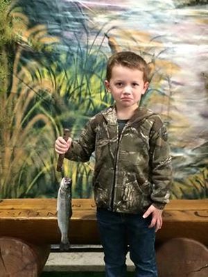 Tyler Smith, age 4, frowns with the trout he caught at the 2015 Big Horn Outdoor Adventure Show.   (Courtesy)