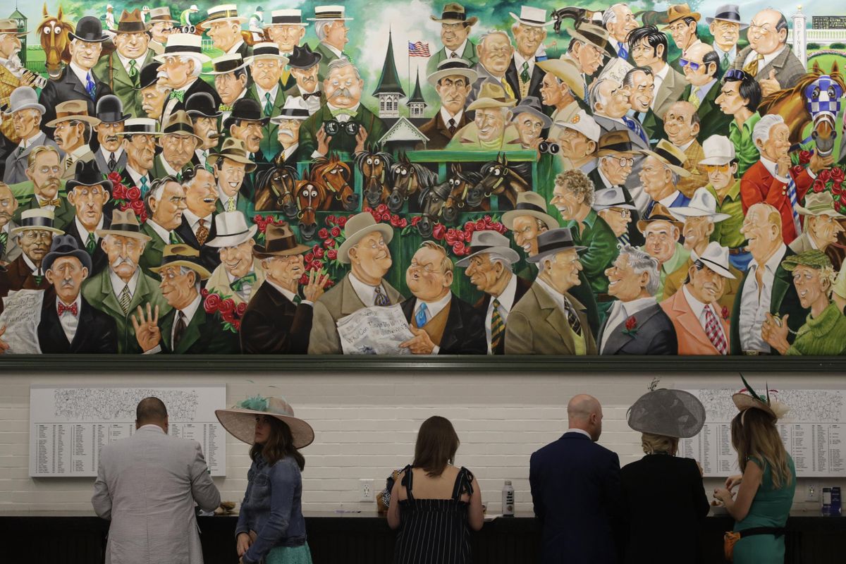 People arrive at Churchill Downs Saturday, May 4, 2019, before the 145th running of the Kentucky Derby horse race in Louisville, Ky. (Charlie Riedel / Associated Press)