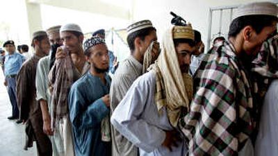 
Arrested  religious students arrive at a sports complex from the Adiala jail to be handed over to their families Sunday in Islamabad. Associated Press
 (Associated Press / The Spokesman-Review)