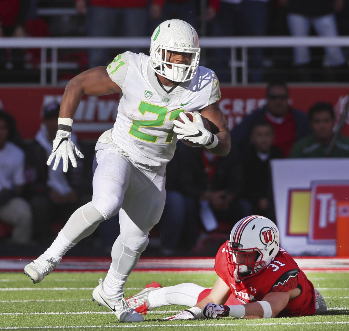 In this Nov. 19, 2016, file photo, Oregon running back Royce Freeman, left, runs past Utah linebacker Evan Eggiman in the second half of an NCAA college football game in Salt Lake City, Utah. (George Frey / Associated Press)