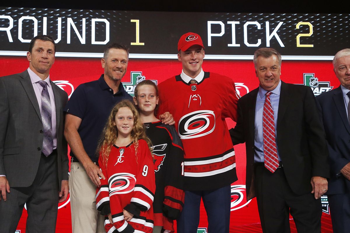 Andrei Svechnikov, center, of Russia, poses after being selected by the Carolina Hurricanes during the NHL Draft in Dallas on Friday. (Michael Ainsworth / AP)