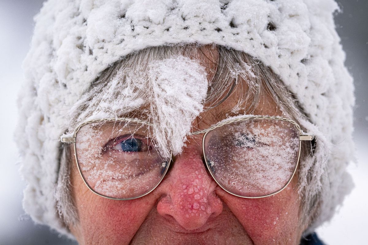 Karen Bart’s hat, face and glasses get covered in snow as she uses a snowblower on her neighbors’ sidewalks on Wednesday along the 2900 block of South Lamonte Street.  (COLIN MULVANY/THE SPOKESMAN-REVIEW)