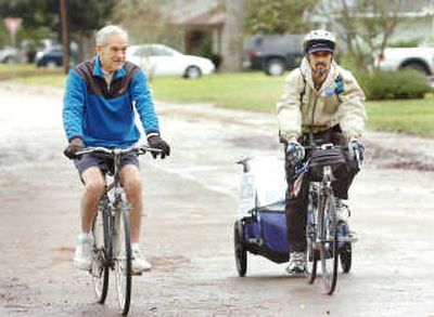
Presidential hopeful Rep. Ron Paul, R-Texas, left, joins Michael Maresco on a ride through Paul's hometown of Lake Jackson, Texas, recently. Maresco is riding his bike across the country, from Santa Monica, Calif., to Washington, D.C., to support Paul and bring attention to the campaign. Associated Press
 (Associated Press / The Spokesman-Review)