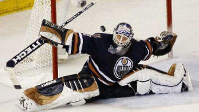 
Oilers goalie Jussi Markkanen reaches in vain to stop a shot by Mark Recchi.
 (Associated Press / The Spokesman-Review)