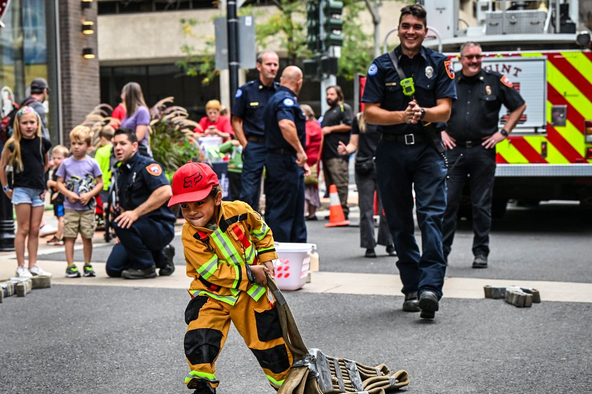 Royal Daniel shows his determination as he begins the combat challenge by hauling a bundled hose down the course and back at the Junior Fire Academy on Sunday in downtown Spokane. The Spokane Fire Department, SAFE Kids Spokane, the Downtown Spokane Partnership and River Park Square partnered for the fifth-annual event.  (DAN PELLE/THE SPOKESMAN-REVIEW)