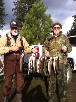 Anglers show off limits of trout they caught on Dec. 1, 2012 - the opening day of Washington's winter trout fishing season at Hatch Lake near Colville. (Bill Baker / WDFW)