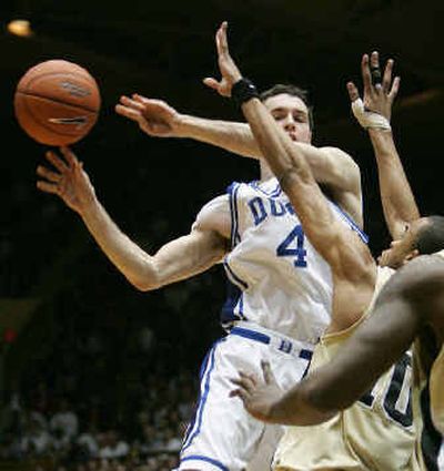 
Duke's J.J. Redick passes around Wake Forest's Jamaal Levy during the first half of the Blue Devils victory. 
 (Associated Press / The Spokesman-Review)