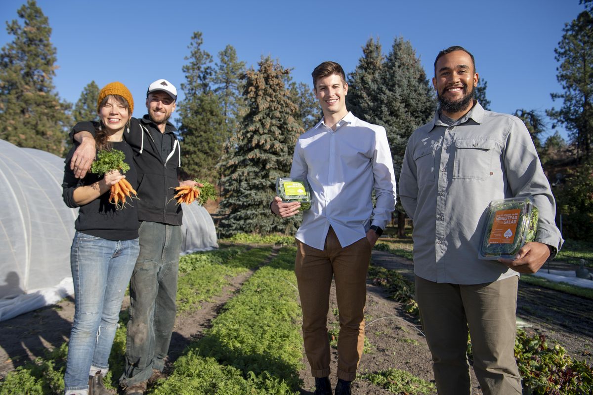 Farmers Amy Dolomont and Alex Ekins, left, have worked with entrepreneurs Eric Kobe, and Vince Peak, right, shown in the garden at Ace of Spades Farm. Kobe and Peak have come up with an app to help customers find local farmers and other specialty food producers. (Jesse Tinsley / The Spokesman-Review)