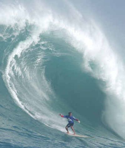 
A surfer takes a large wave Wednesday in the first heat of The Quiksilver In Memory of Eddie Aikau Big Wave Invitational at Waimea Bay in Haleiwa, Hawaii. The contest is held at Waimea Bay only when the waves reach at least 20 feet.
 (Associated Press / The Spokesman-Review)