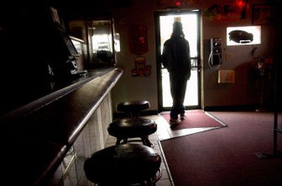 
A customer exits an empty Comet bar Tuesday afternoon in Hillyard. The clean indoor air law passed by voters in November has left the neighborhood's bars competing for business.
 (Brian Plonka / The Spokesman-Review)